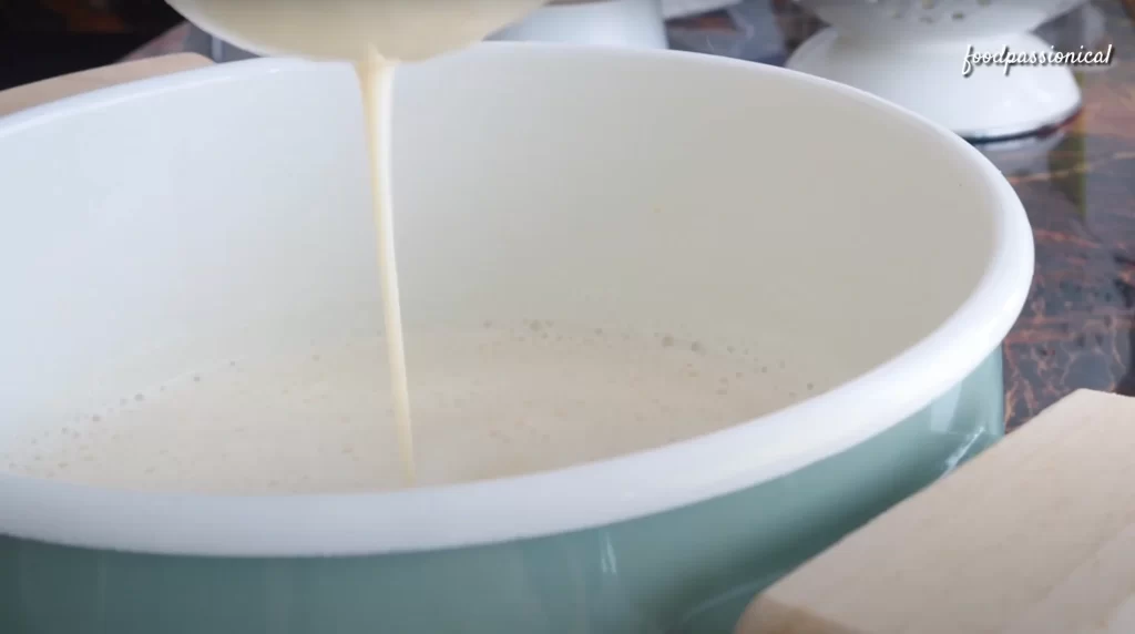 squeezing the soy milk with a cheesecloth