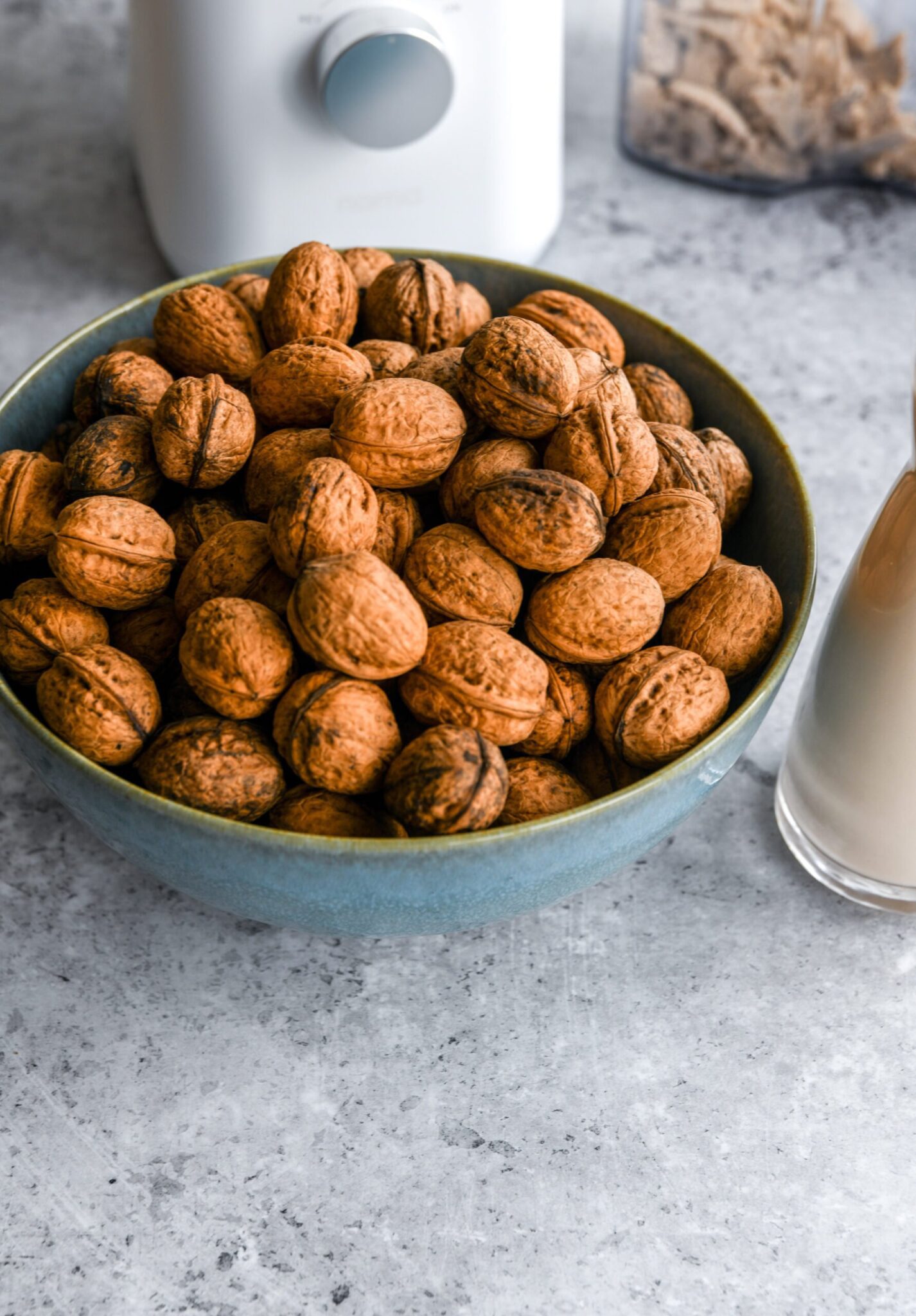 a blue bowl of walnuts