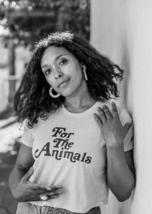 Yvette Baker pictured in Black and White wearing a shirt that says "For the Animals"
