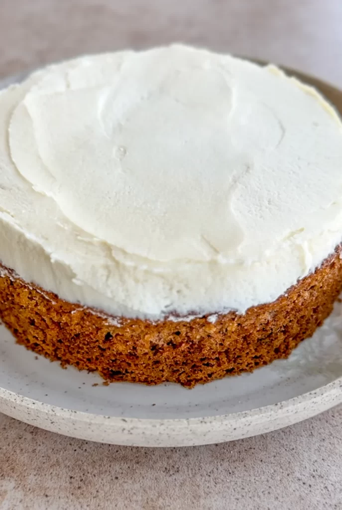 one carrot pistachio cake layer with cream cheese frosting on top