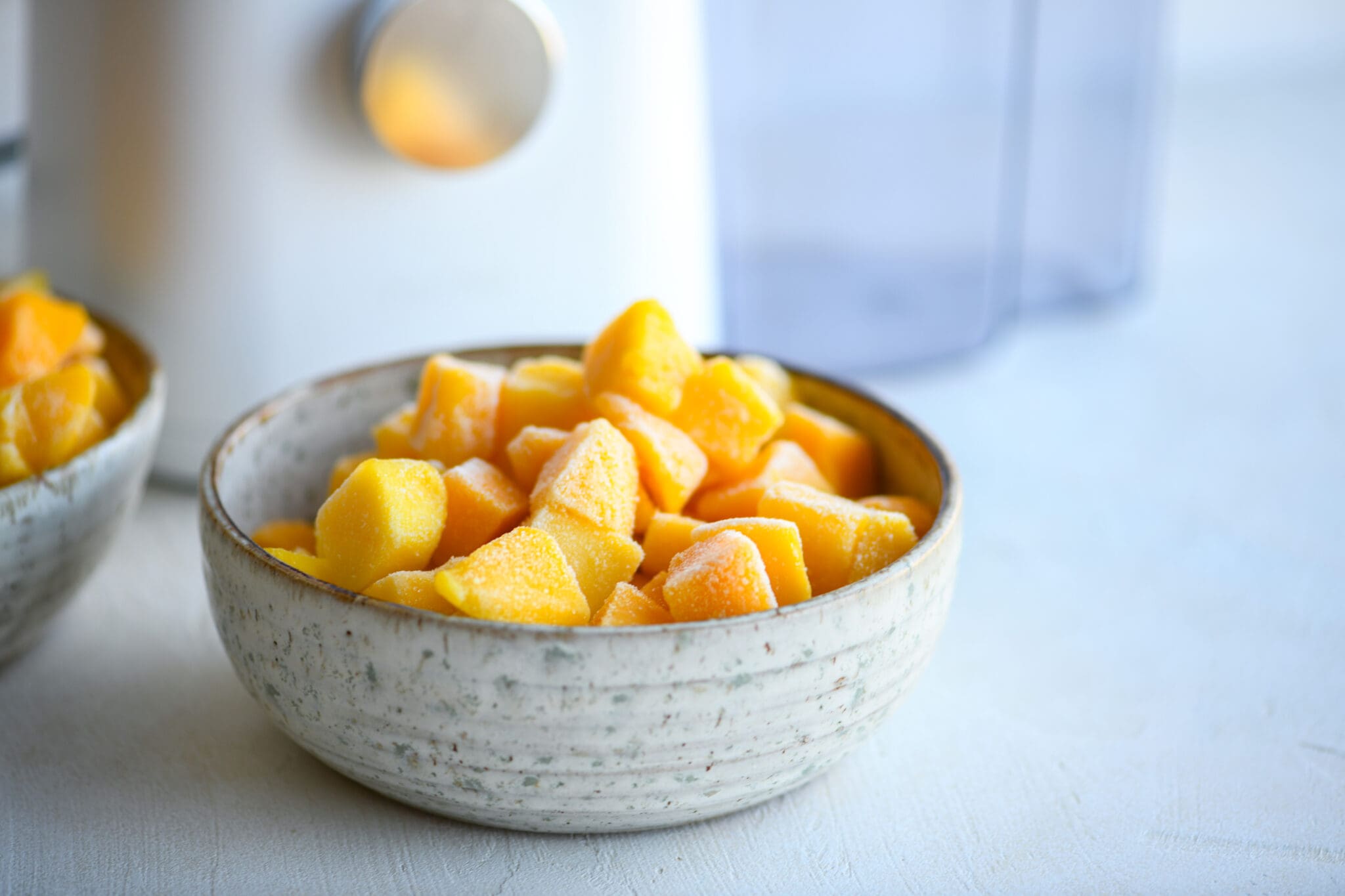 frozen fruit in front of juicer