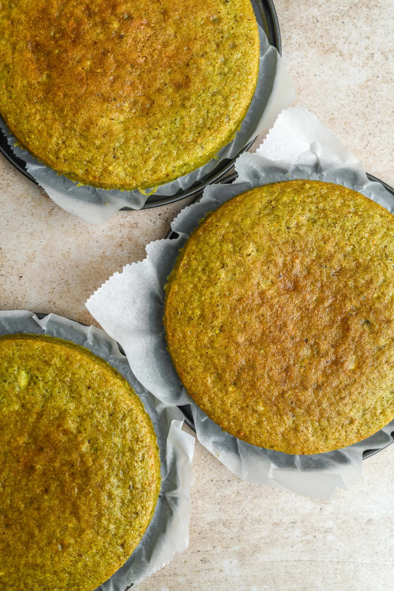 three baked vegan pistachio cakes